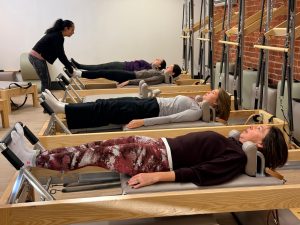 Clare Axon-Saunders teaching reformer pilates at the pilates barns